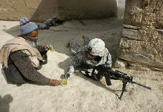 An Afghan Man offers Tea to Soldiers